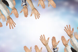 Group of people with hands up showing gestures