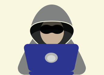 A man wearing a grey hoodie and sunglasses is on a laptop.
